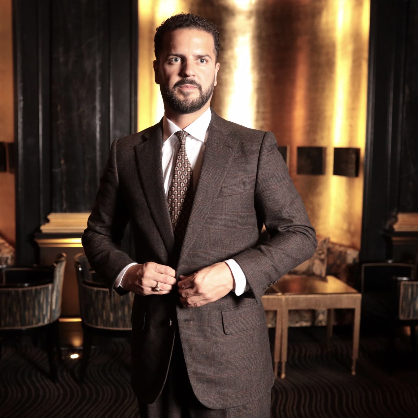 Single-breasted charcoal suit paired with a classic striped tie, perfect for corporate meetings.